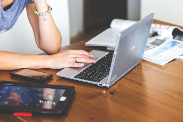 Woman working on a laptop at a desk 