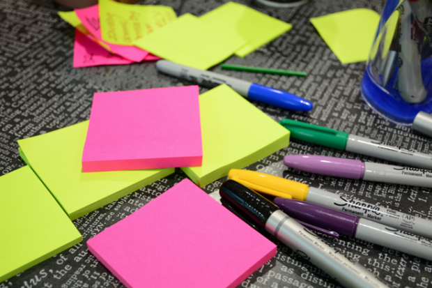 blank post-it notes and sharpie pens on a desk 