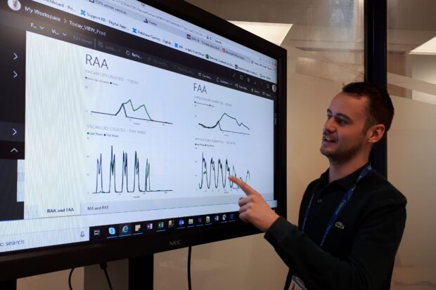  Niall talking looking at a screen and talking about  data from Find an Apprenticeship 