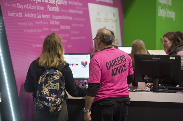 A National careers service colleague talking to an attendee at The skills show in the NEC