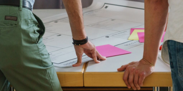 Two colleagues working using post its and a chart